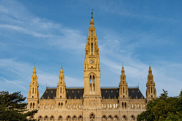 Majestic Gothic Architecture with Clock Tower and Ornate Facade under Clear Blue Sky