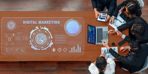 A team of professionals collaborates on a digital marketing strategy, utilizing technology, data visualization, and innovative tools at a modern office desk. Trope