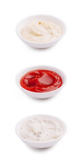 Three different sauces served in small bowls on a white background