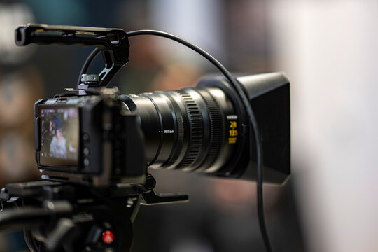 Doha, Qatar - November 05, 2025:  Nikon ZR series mirrorless camera mounted on a tripod and recording a video in an outdoor setting.