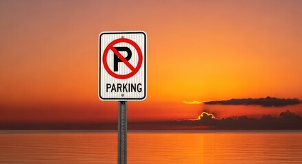 A no parking sign against a vibrant sunset sky over water.