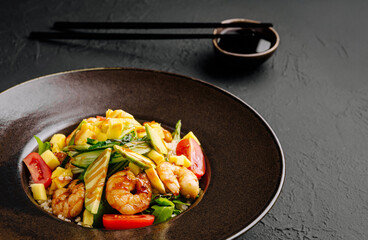 Colorful shrimp stir-fry with fresh vegetables served in a black bowl