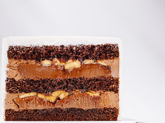 Delicious chocolate and banana layered cake cut to show filling and texture