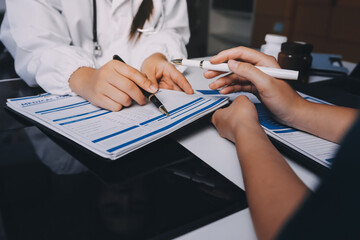 Group of doctors attending seminar in hospital lecture hall with senior physician giving medical presentation and professional training session on healthcare practices