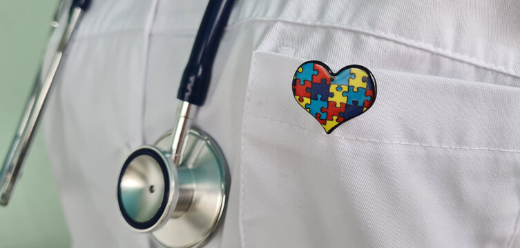 A Doctor Wearing a Stethoscope and a Puzzle Piece Heart Pin