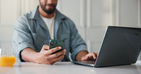 Freelancer, laptop and hands with smartphone, home and research for ebook marketing on social media. Online, brand awareness and self publisher with tech for novel promotion, web and person in house