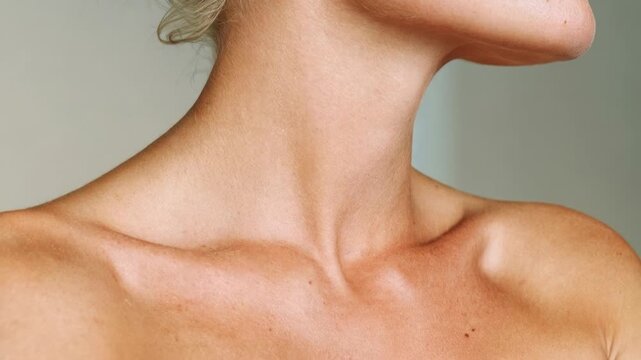Elegant neck and collarbone closeup glows with soft light celebrating skincare femininity and jewelry friendly beauty where simplicity confidence and quiet luxury meet in a timeless minimal