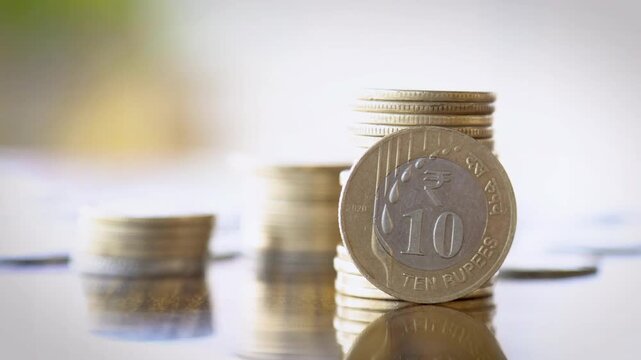 Smooth Focus Transition from Blur to Sharp Stack of Coins with Vertical 10 Rupee Coin