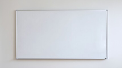 A pristine whiteboard mounted on a plain wall, ready for presentation, brainstorming, and collaborative work in an educational setting.