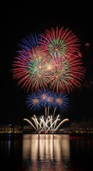 Spectacular fireworks display illuminating the night sky over tranquil waters with city lights