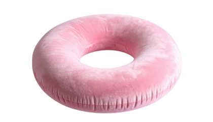 A fluffy, donut-shaped, inflatable, pink object against a black backdrop, appears soft with a velvet-like texture and a defined hole in the center