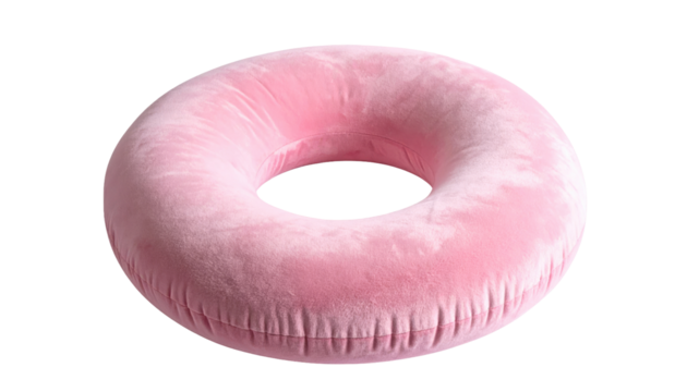A fluffy, donut-shaped, inflatable, pink object against a black backdrop, appears soft with a velvet-like texture and a defined hole in the center