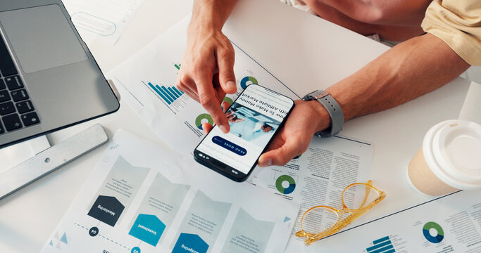 Graphs, above or hands in office with phone screen, market update or browse in new revenue stream. Tech, man or analyst in agency with paper, online article or growth opportunity for company report.