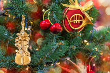 Christmas tree decorated with musical instruments, violin and cherries. Copy space