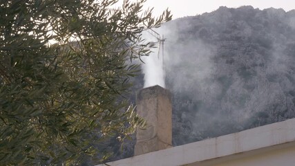 White smoke coming out of a rustic brick chimney..