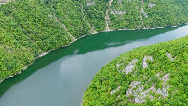 Aerial drone view of the Vrbas River in Bosnia and Herzegovina, flowing through green canyons and rocky cliffs, nature scenic travel holiday destination Europe