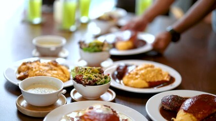 Serving Japanese Omurice and Hamburg Steak at Restaurant Table - Powered by Adobe