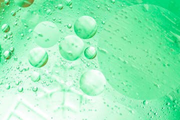 Beautiful and fantastic macro photo of water droplets in oil with a blue background. Abstract art