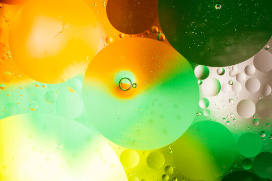 Beautiful and fantastic macro photo of water droplets in oil with a blue background. Abstract art