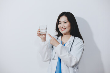 Portrait of Asian doctor woman standing holding coffee cup in white studio background