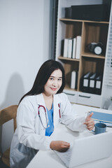 Receptionist working at the hospital registering patients