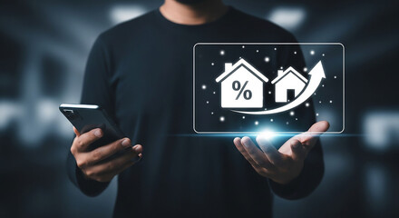 Man holding a smartphone and a holographic display showing a rising graph with house icons and a percentage symbol, symbolizing real estate growth and investment.