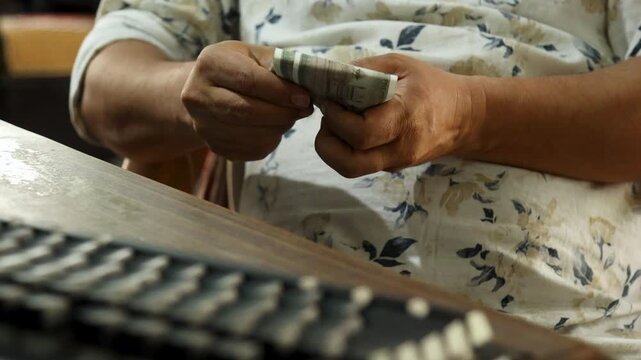 Indian Man Counting ₹500 Notes Before Laptop, Offering Salary to Employee