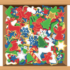 A festive overhead view of a wooden crate brimming with colorful assorted Christmas-themed cutouts, perfect for holiday crafting and decorations