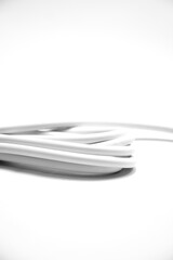 Close-up of white Electrical Cables with Exposed Copper Wires on White Background. Electric cables plug used to instalation in commercial and industrial Electrical Systems. Macro detail of stripped	