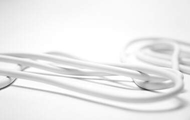 Naklejka premium Close-up of white Electrical Cables with Exposed Copper Wires on White Background. Electric cables plug used to instalation in commercial and industrial Electrical Systems. Macro detail of stripped 