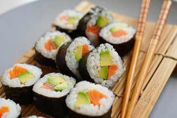 Delicious Sushi Rolls with Salmon Avocado and Rice Served on Bamboo Mat Ready to Eat