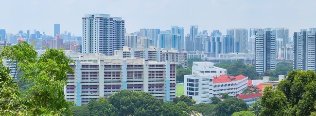 Urban skyline with lush green trees in the foreground