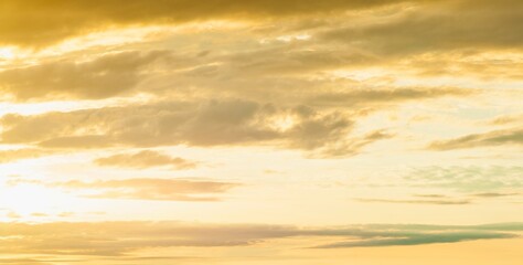 Golden hour sky with wispy clouds and horizon