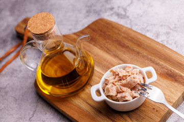 Gourmet canned tuna on wooden board top view