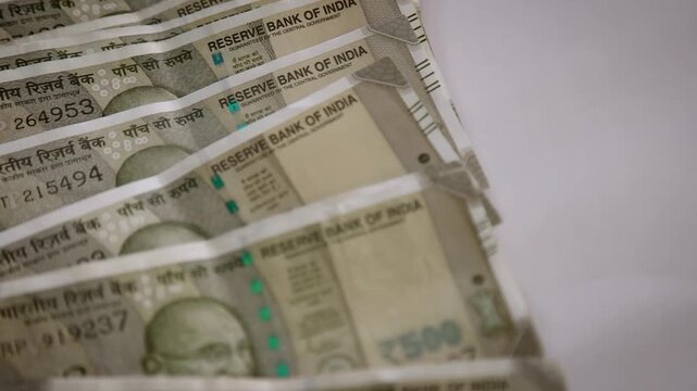 Rollover of Indian ₹500 Banknotes on a Plain White Surface in Slow Motion