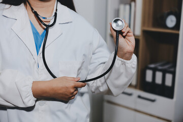 A young male doctor holding an stethoscope