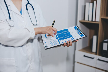 Portrait of female doctor, holding file