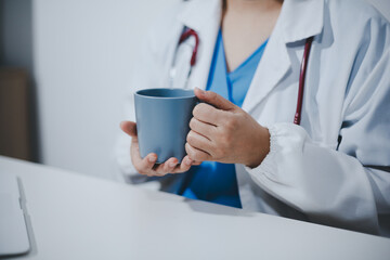 Female scientist holding coffee mug in laboratory