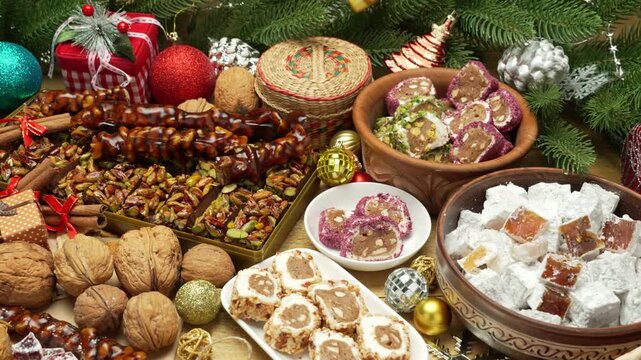 Beautiful and festive Christmas background with candies and sweets and decorations, Sweet food Turkish delight on wooden background, assorted locum and candy for decorated backdrop
