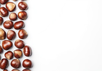 A neat vertical line of whole chestnuts with glossy shells on a clean white background