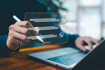 Business person using digital stylus to fill and sign an online checklist form on a laptop with...