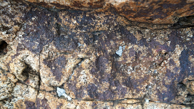 Close-up of natural gold ore with rough texture and metallic flecks