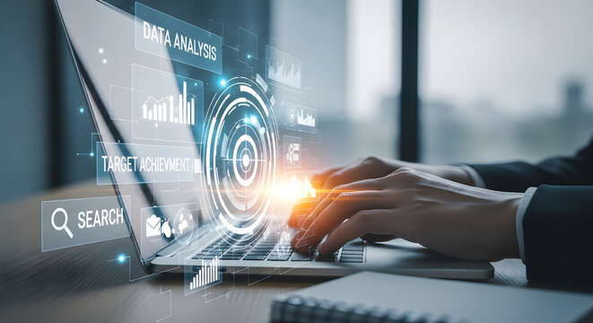 Person typing on a laptop with futuristic digital interface and glowing data visualizations