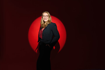 successful business woman isolated on red spot light background with copyspace. Beautiful Personal Growth Keynote Speaker.