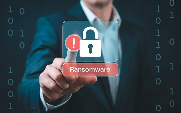 A businessmans finger touches a screen displaying a locked padlock icon with an exclamation mark and the word ransomware, signifying a cyber security threat - Powered by Adobe