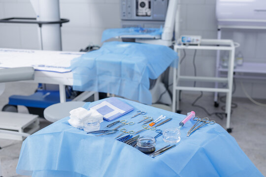 Sterile surgical instruments set on tray in a modern operating room