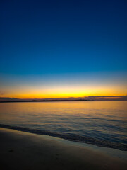 Fototapeta premium gold sunset at the beach with blue sky