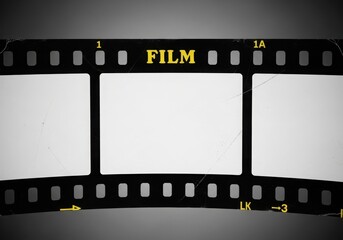 Fototapeta premium Closeup of a vintage film strip the word film in yellow letters on a dark background