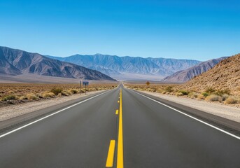 Endless desert highway stretching towards distant mountains under a clear blue sky