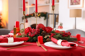 Stylish Christmas table setting with plates, festive decor and candles indoors, closeup